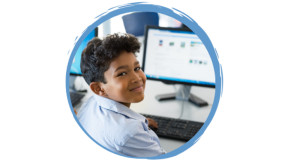 School student smiling at laptop